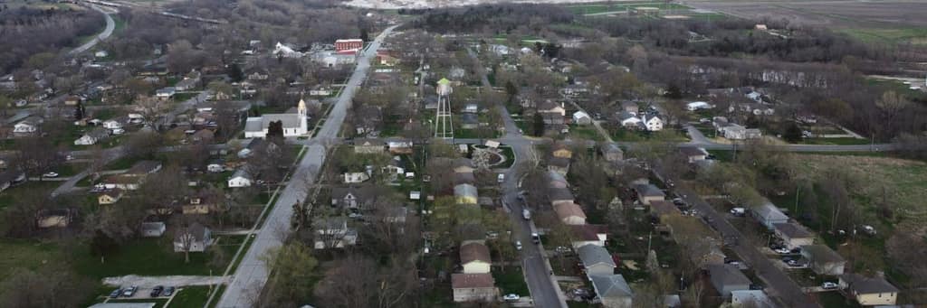 A drone view over Edgerton neighborhoods and tree-lined streets